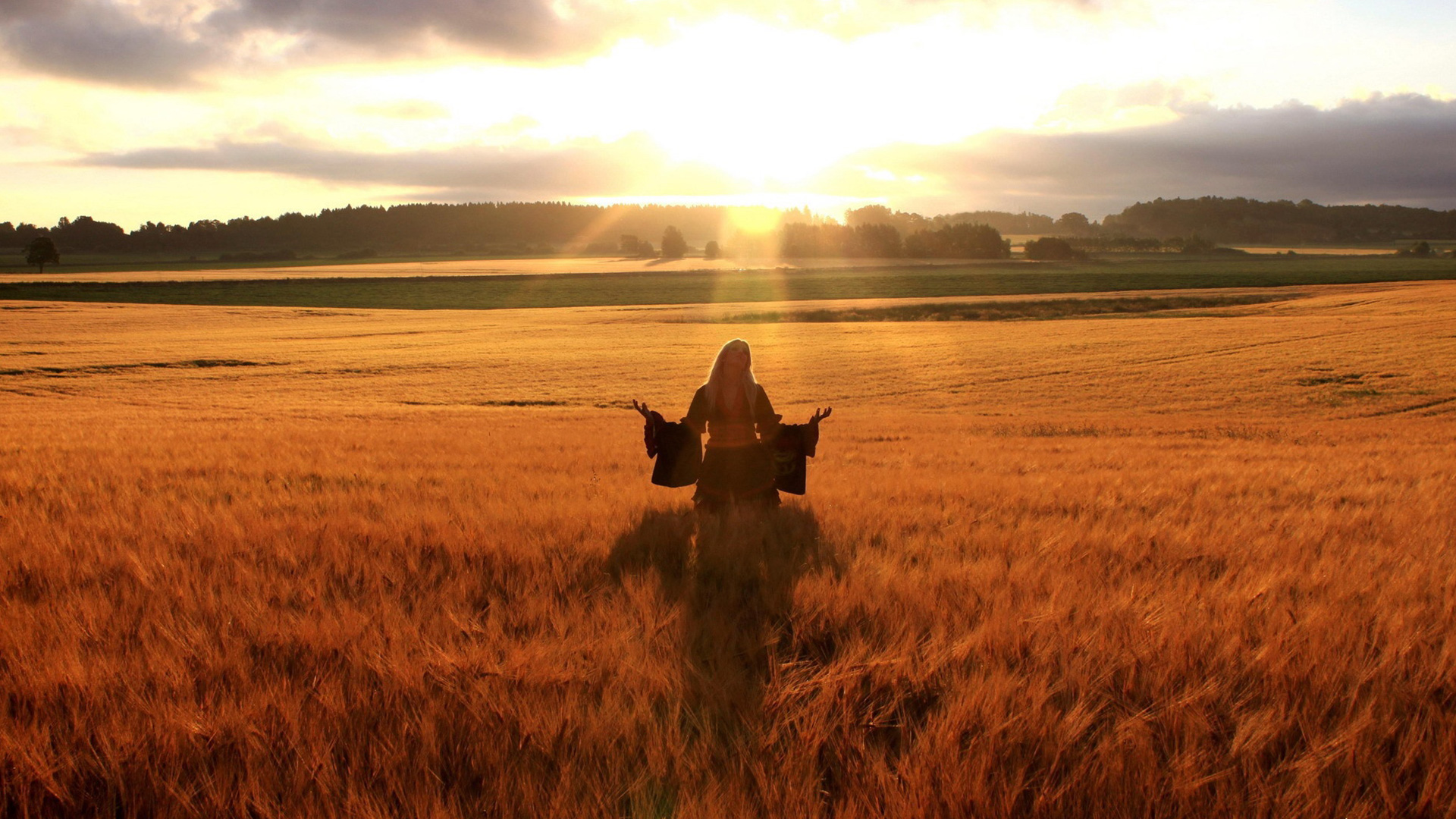 Happy Woman In Field At Sunset